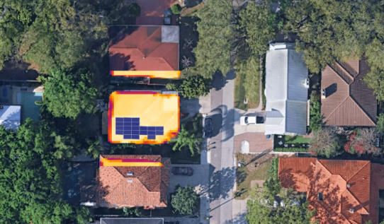 Aerial view of a house roof with solar panel layout and heat map for system sizing